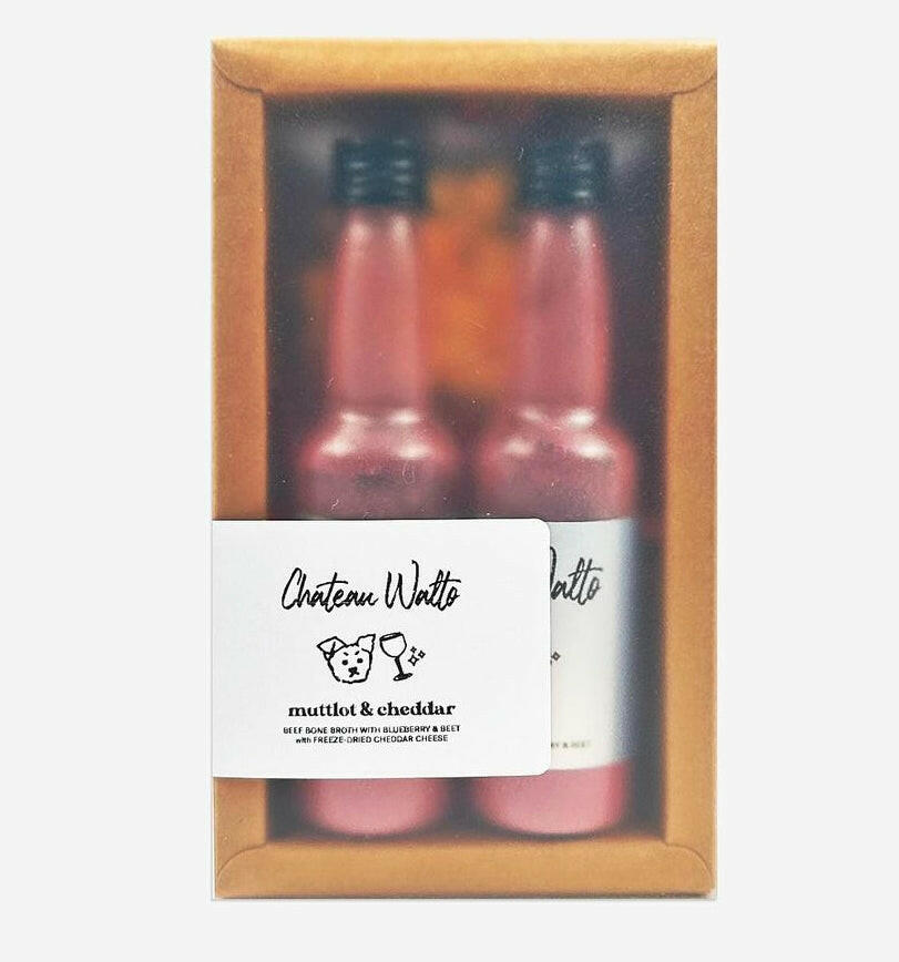 Chateau Walto "Muttlot & Cheddar" wine and cheese kit for dogs in a gift box, featuring two bottles and packaging.