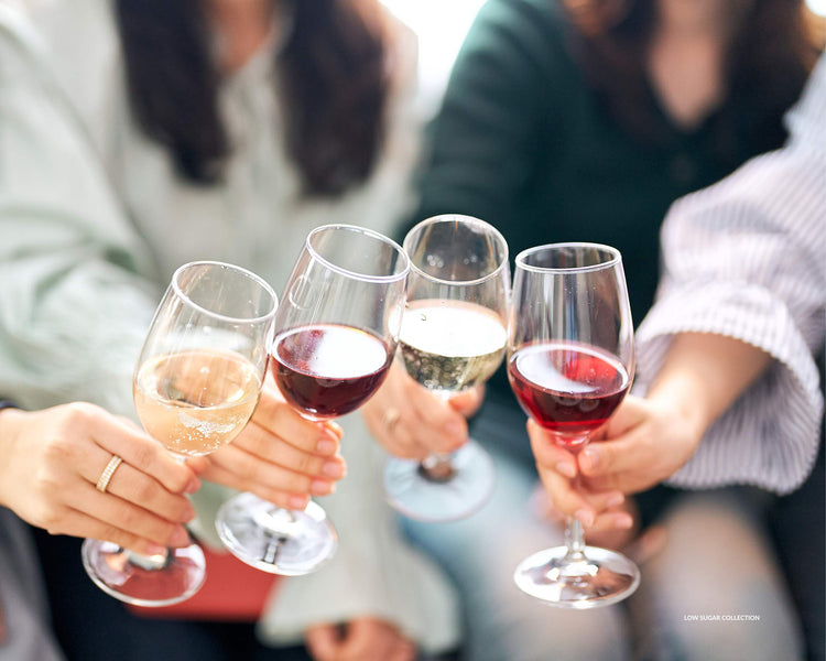 Cheers with glasses of white wine, red wine and rose wine 