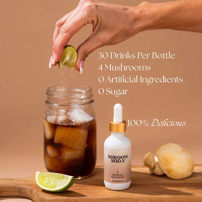 Shroom Soda bottle with a hand adding a lime wedge to a glass of iced drink on a wooden surface.